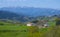 Landscape view of green meadows mountains and a small farm, Basque Country