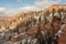 A landscape view of Hop valley with a thin layer of snow dusting the red rocks and green pines