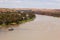 Landscape view of houseboat cruising upstream on the Murray River near Young Husband in South Australia