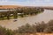 Landscape view of houseboat cruising upstream on the Murray River near Young Husband in South Australia