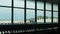 Landscape view from inside departure terminal hall area to outside at aircraft airplane parking area with planes operating in rush