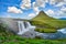 Landscape view of Kirkjufellsfoss In the daytime, blue sky and beautiful clouds. The waterfall is famous and a popular tourist