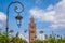 Landscape view of the Koutoubia mosque minaret and on street lamp.