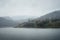 Landscape view of mountain village on Zaovine lake in fogg