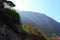 Landscape view of the mountains with green lush trees and sun beams coming from the side