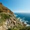 Landscape view of mountains surrounded by ocean in Hout Bay in Cape Town, South Africa. Beautiful popular tourist