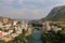 A landscape view of the old town of Mostar, with the old bridge over the river