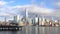 Landscape view of people enjoying the day at Jersey City`s riverfront, with the New York Ci