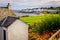 Landscape view of Port Charlotte houses on an ocean coastline, Isle of Islay, Scotland, UK