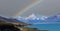 The Landscape view of rainbow scene with mountain range near Aoraki Mount Cook and the road leading to Mount Cook Village in New