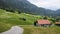 Landscape view of the roofs of traditional swiss houses, mountain Alps, green meadows, lawn. Incredibly bewitching and