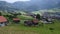 Landscape view of the roofs of traditional swiss houses, mountain Alps, green meadows, lawn. Incredibly bewitching and