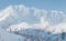 Landscape view of ski touring couple hiking up a mountain in the Low Tatras in Slovakia.