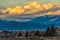 Landscape with view on smal town with mountains and clouds