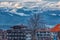 Landscape with view on small town with mountains and clouds