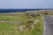 Landscape view of stone walls and road along the rugged terrain of Inishmore, in western Ireland