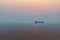 Landscape view  in sunset general cargo ship with reflection