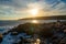 Landscape view of sunset at Otter Point. Waves crashing on rocks