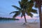 Landscape view of sunset over Muri lagoon with empty hammock in