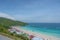 Landscape view of tawean beach with crowded of tourist on the beach in cloudy day.