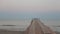 Landscape view of Tranquil Sunrise on the sea with wooden pier.