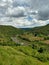 Landscape view of a valley with a hilly river and agriculture field