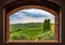 Landscape view of vineyards from the brick window, Tuscany, Italy