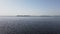 Landscape with a view of a wide river and an island covered with trees in the early spring morning