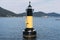 Landscape view of yellow and black lighthouse in the ocean in Busan, South Korea