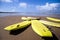 Landscape view of yellow surfboards on beach.