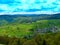 The landscape of the village with a vineyard, forest, hills.