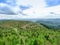 The landscape of the village with a vineyard, forest, hills.