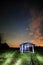 Landscape with vintage wooden shack under the stars light