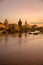 landscape with Vltava river, Karlov most and boat at sunset in autumn in Prague