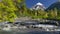 Landscape with volcano, mountain river and green trees. Lanin volcano in Lanin national park. Argentina, Patagonia, Lake