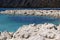 Landscape of white rock formations and body of water, lagoon of turquoise blue colors. Laguna de Alchichica, Puebla Mexico