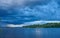 Landscape. The wide river, the sandy coast of the river overgrow