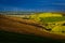 Landscape with wind turbines. Green field and freshly ploughed field. Location: Romania