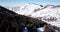 Landscape winter forest. Mountain area. A group of people goes and rides in the mountains on a snow-covered trail.