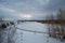 Landscape winter river, sky in the clouds, sunbeam