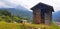 Landscape with a wooden hayloft against the backdrop of the village