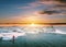 Landscaped, Beautiful glacier lagoon in sunset with a guy paddle boarding