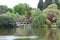 Landscaped mature english garden with a bridge over a lake