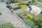 Landscaped public garden with flowers, trees sculptures and peo