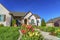 Landscaped yard of a home with pathway stairs tulips trees and grasses