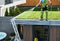 Landscaper Watering Green Roof Sedum Plants Newly Installed on a Roof