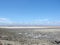 Landscapes of Genichesk pink salt lake on a background of slightly cloudy blue autumn sky.