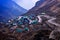 Landscapes of Nathang Valley, East Sikkim, India. Mesmerizing view of a small village under clouds and zig-zag road.