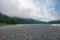 Landscapes of Siberia. Early morning on the Kiya river. Fog descends on the river over the taiga.