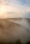 Landscapes of Siberia. Early morning on the Kiya river. Fog over a forest in the mountains.